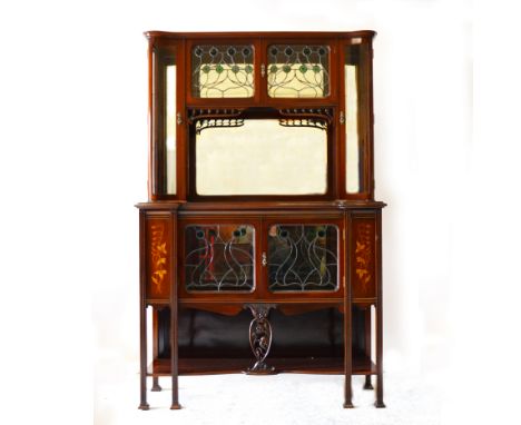 An Art Nouveau mahogany display cabinet, circa 1910, the superstructure with mirrored back behind an arrangement of glazed cu