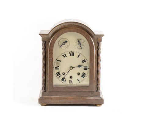 German oak cased mantel clock, arched silvered dial, movement striking on five gongs, 34cm.