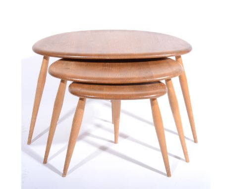 A nest of three elm and beech 'Pebble' tables by Ercol, shape 354, maximum width 65cm, depth 45cm, height 40cm. (Qty: 3)