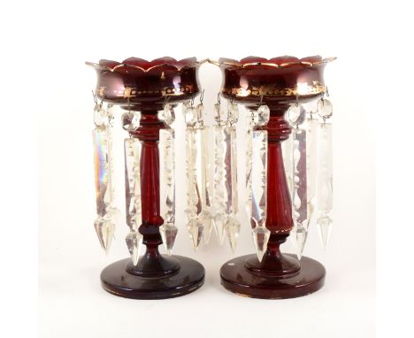 Pair of ruby glass lustres, with prismatic drops, gilt decoration, 33cm.