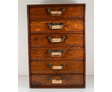 A collectors cabinet by Henry Stone &amp; Son, Banbury, 31cm x 45cm x 26cm, six drawers containing a quantity of uncut gemsto