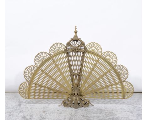 A brass folding pierced fan design firescreen 60cm high.