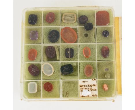 A collection of 24 small intaglios in various stones including carnelian, amethyst and agate and depicting various figures an