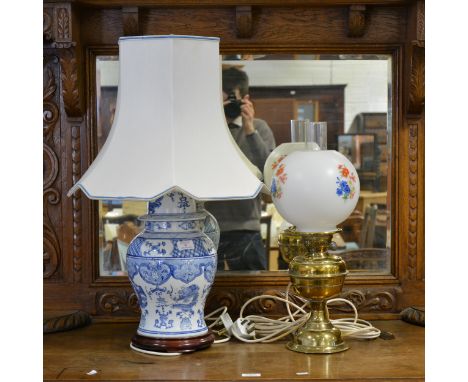 Brass oil lamp, converted to electricity, modern opaque globe, chimney 52cm; a Chinese blue and white lamp base. (2)