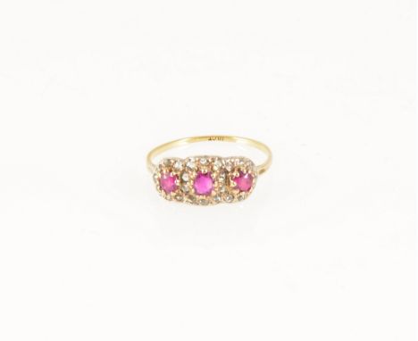 A ruby and diamond cluster ring, three rubies and twenty-four rose cut diamonds, set as a triple cluster in a yellow and whit