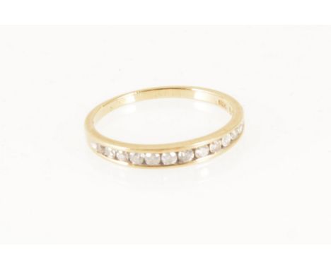 A diamond half eternity ring, twelve brilliant cut diamonds graduating in size, channel set in a 9 carat yellow gold mount, 0