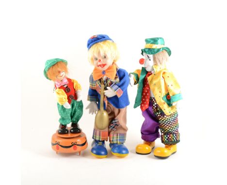 Modern musical clown automaton, 56cm; and two other musical walking clowns. (3)