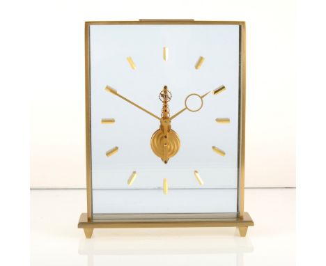 An eight day Jaeger-LeCoultre slimline mystery clock, brush textured brass, double glazed slimline case, inset gilded brass h