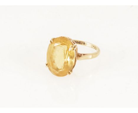 A citrine dress ring, the oval mixed cut stone 16mm x 12mm, set by four double claws in a 9 carat yellow gold mount, hallmark