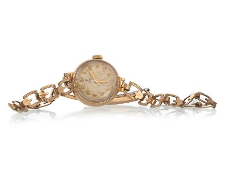 TUDOR ROYAL NINE CARAT GOLD MANUAL WIND WRIST WATCH,  the round dial with Arabic hour markers, 19mm case, on a rolled gold br