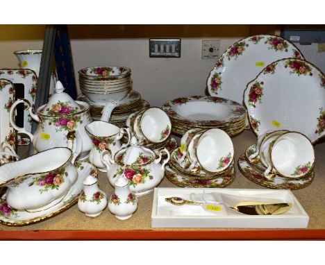 A ROYAL ALBERT OLD COUNTRY ROSES DINNER AND TEA SERVICE, comprising a part boxed cake slice, salt and pepper, a teapot and co
