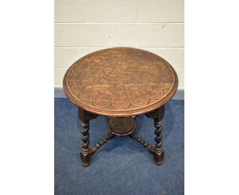 A 1920'S CIRCULAR CARVED OAK CENTRE TABLE, on angled barley twist legs united by bobbin turned stretchers, diameter 78.5cm x 