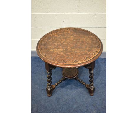 A 1920'S CIRCULAR CARVED OAK CENTRE TABLE, on angled barley twist legs united by bobbin turned stretchers, diameter 78.5cm x 