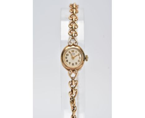 A 9CT GOLD HAND WOUND ROLEX TUDOR LADY'S WRISTWATCH, a round case measuring approximately 15mm in diameter, cream dial signed