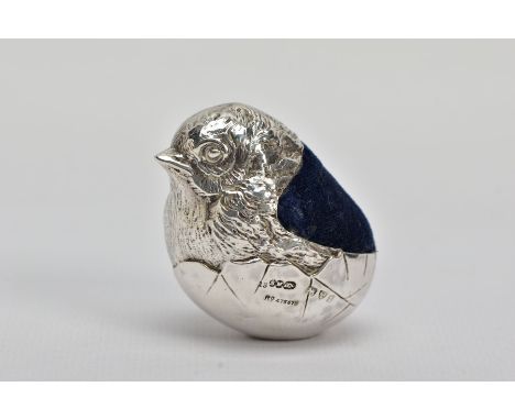 AN EARLY 20TH CENTURY SILVER PIN CUSHION, in the form of a realistically textured hatching chick, blue velvet cushion, hallma