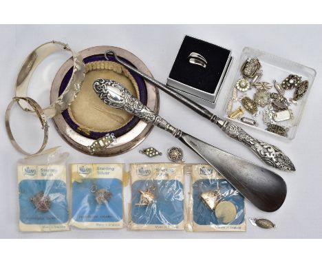 A SELECTION OF SILVER AND WHITE METAL ITEMS, to include four 'Nuvo' sterling silver charms in original packaging, in forms su