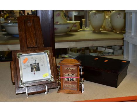 AN OAK CASED PERPETUAL CALENDAR, height 16cm (numbers not working), together with a small oak barometer (missing thermometer)