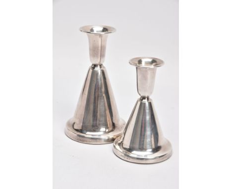 TWO NORWEGIAN SILVER DOMED CANDLESTICKS, each of a plain polished design, on round weighted bases, the first approximate heig