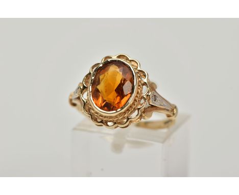 A 9CT GOLD CITRINE AND DIAMOND RING, centring on a collet mounted oval cut citrine, openwork scallop surround, trifurcated si