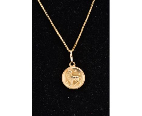 A YELLOW METAL PENDANT NECKLACE, the pendant of a circular form with the zodiac lion sign 'Leo', approximate width 12.0mm, fi