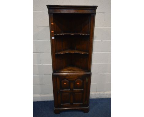 AN OAK REPRODUCTION GEORGIAN STYLE OPEN CORNER CUPBOARD, with two shaped shelves above a multi panelled cupboard door enclosi