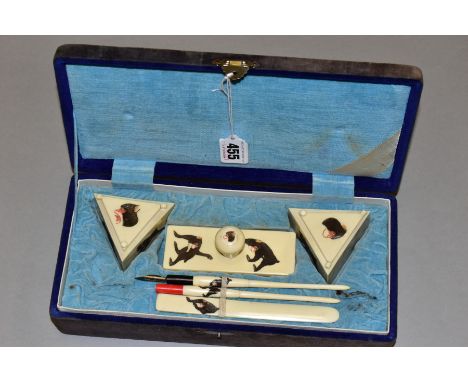 A VINTAGE ORIENTAL CALIGRAPHY SET, constructed with faux ivory decorated with inscribed and painted monkey decoration compris