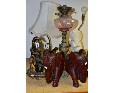 A VICTORIAN CAST IRON MR PUNCH DOORSTOP, later painted decoration, height 31cm, a pair of wooden elephant wall masks, a small