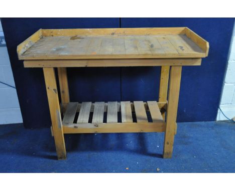 A MODERN PINE GREENHOUSE POTTING TABLE with slatted under shelf