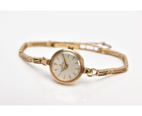 A LADIES 1950'S 9CT GOLD OMEGA WRISTWATCH, the circular face with tapered baton hour markers and gate style articulated strap