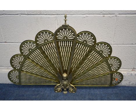 A BRASS FAN FIRESCREEN, with a mythical figure to centre