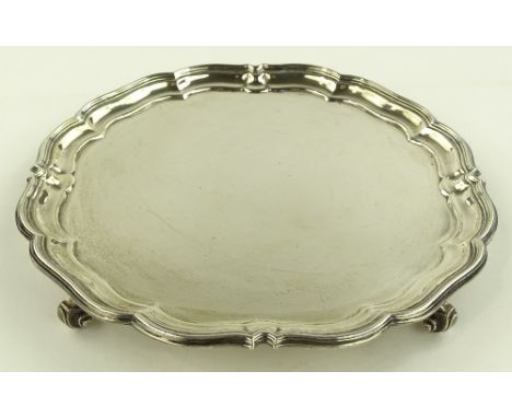 A circular silver salver with scalloped edge by Harrison & Howson, Sheffield 1932, diameter 25.5cm, 18.8oz.