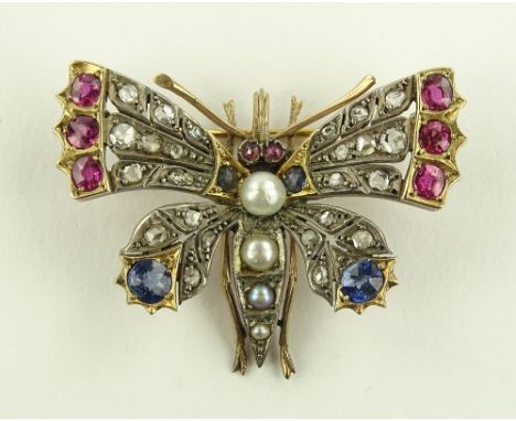 An Art Deco diamond, ruby, sapphire and pearl set butterfly design brooch, circa 1920s, unmarked gold settings, wing span 43m