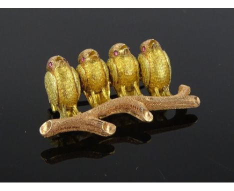 An Edwardian unmarked 3 colour gold brooch in the form of 4 chicks on a branch, with ruby eyes, length 37mm, 12g.