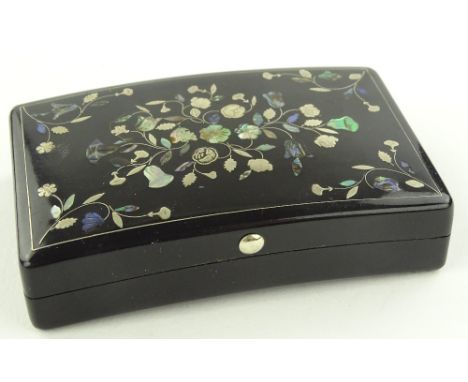 A 19th century tortoiseshell box of concave rectangular form, inlaid silver and mother of pearl floral designs, length 8cm.