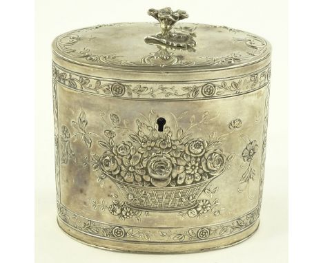 An ornate oval silver tea caddy, with floral knop and relief basket of flowers decoration, import marks Chester 1909, Boaz Mo