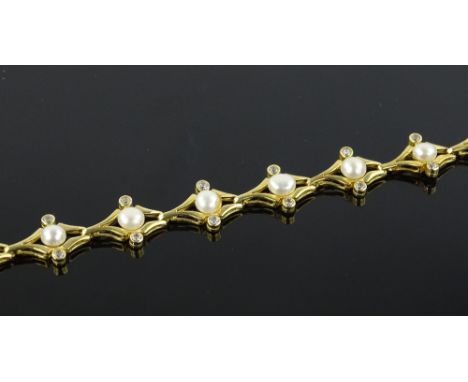 An unmarked gold pearl and white stone set bracelet.
