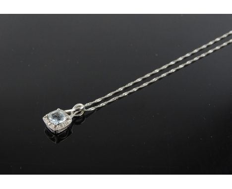 A 9ct white gold topaz and diamond set pendant and chain, pendant length including bale 14mm.