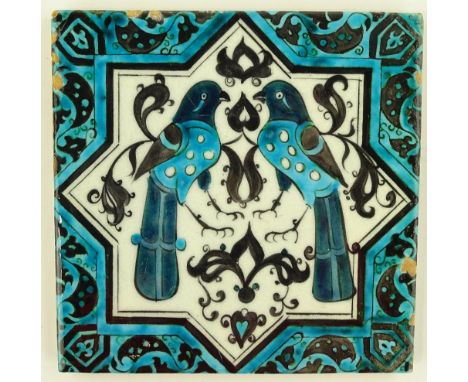 An Islamic pottery tile with painted bird decoration, height 19.5cm.