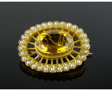 A Victorian citrine and pearl set oval brooch, settings test as high carat gold, length 34mm.