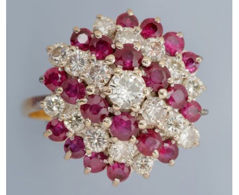 A ruby and diamond dress ring, set with three rows of graduated brilliant cut diamonds and four rows of graduated circular fa