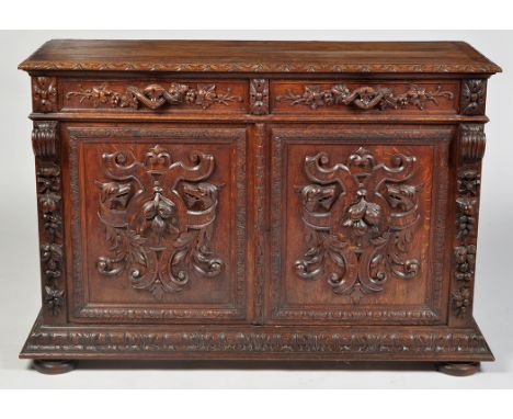 A Victorian carved oak sideboard, the rectangular top with crossbanded edge and carved acanthus design, above a pair of friez