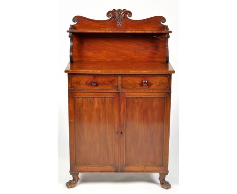 An early 19th Century mahogany chiffonier, the scrolling and carved back fitted a shelf on shaped support, the base fitted tw