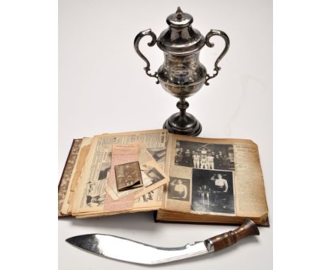The Swords, Cup and Record Book of the previous World Record holder for club and sword swinging, Gunner George Vyner 101 Roya