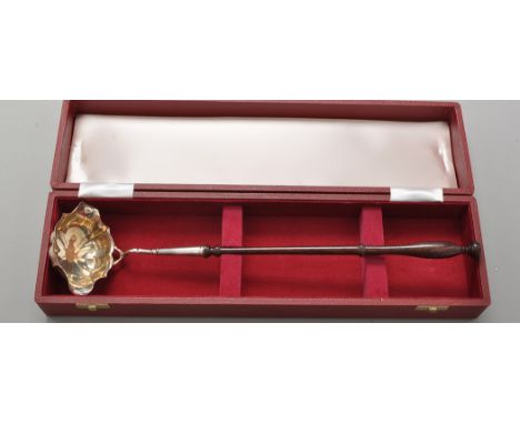 An Elizabeth II punch ladle, by C.J. Vander, London 1974, with double-lipped oval silver bowl, turned wooden handle, in velve
