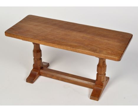 Robert "Mouseman" Thompson, Kilburn: an oak rectangular occasional table, the adzed top raised on octagonal supports joined b