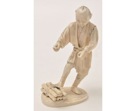 Japanese part ivory figure of a faggot collector, depicted in the process of tying the stick bundle, Meiji Period, character 