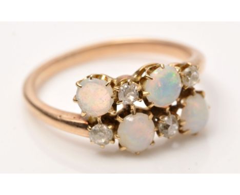 An opal and diamond ring, set four circular cabouchon opals and four old cut diamonds on yellow metal shank, ring size M 1/2.