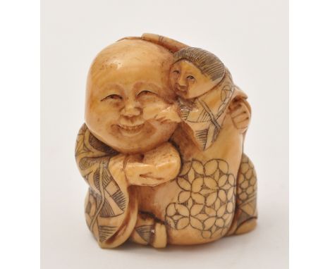 Japanese ivory Netsuke of man holding a child upon his shoulder, the man with joyful expression as the child squeezes his che