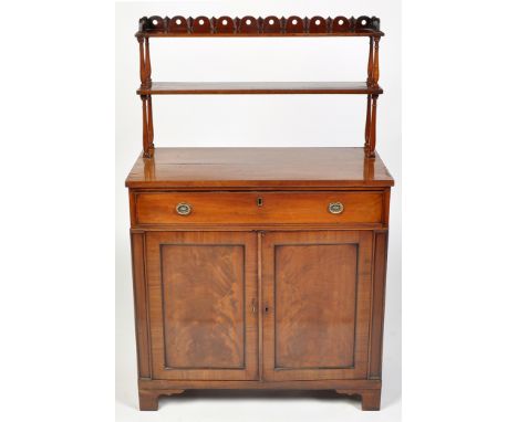 An early 19th Century mahogany chiffonier, the two upper shelves raised on turned supports, the base fitted a single frieze d