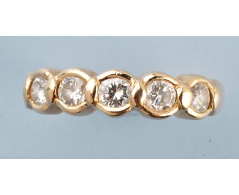 A five stone diamond ring, the brilliant cut graduated diamonds within collet mount, the yellow metal shank stamped '585 14k'